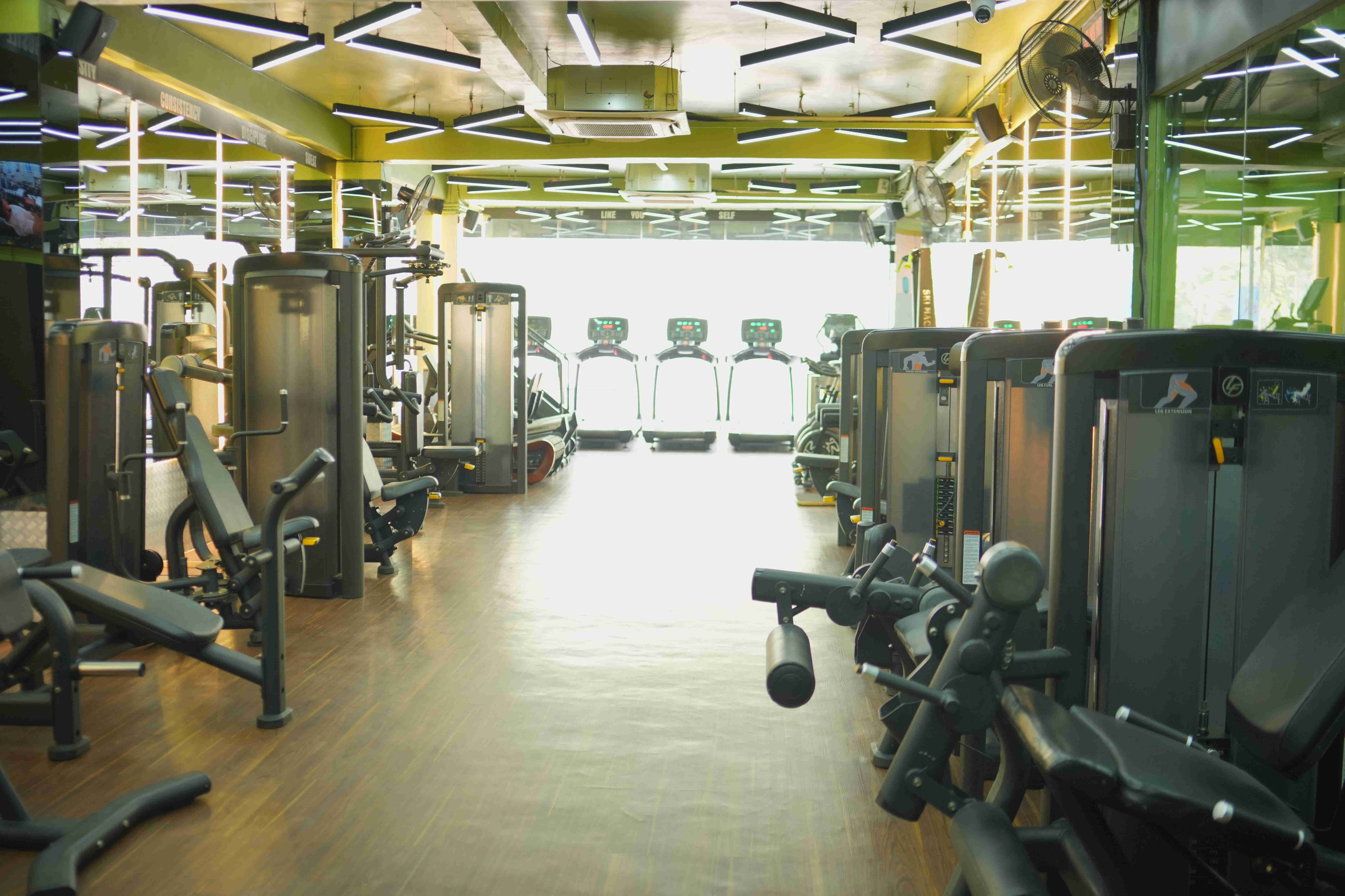 Member holding dumbbells in gym